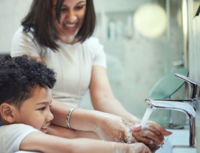 woman and child using sink
