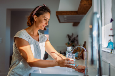 woman using sink for drinking water
